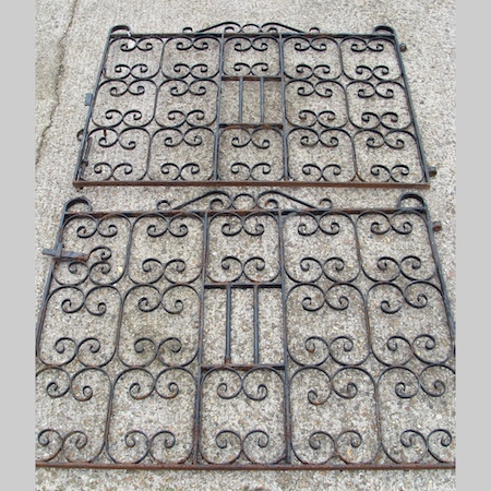 A pair of black painted cast iron gates, 275cm