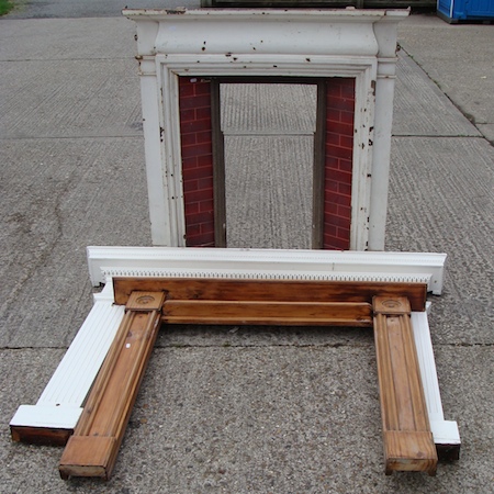 A cast iron and tiled fire surround, 110cm, together with an Edwardian pine surround and another