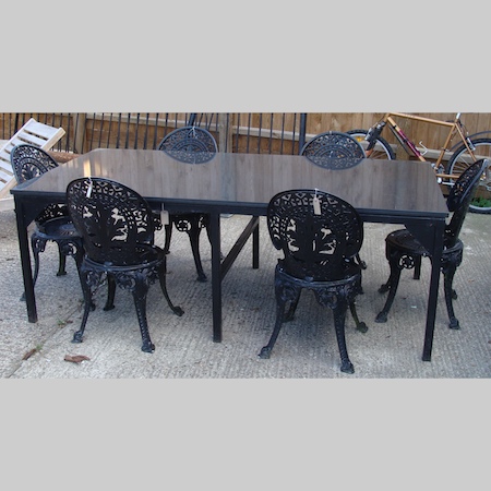 A large black granite garden table, on a metal base, 213 x 110cm together with a set of six black