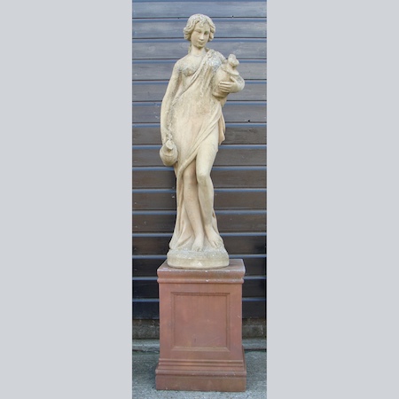 A reconstituted stone figure on a metal pedestal base, 190cm tall