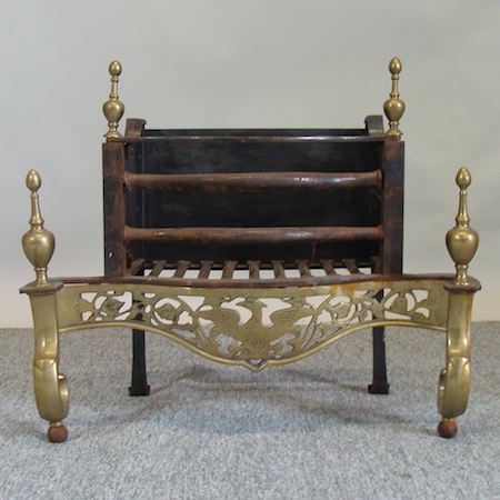 A 19th century pierced brass and iron fire grate