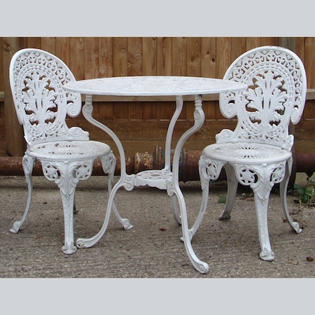 A white painted metal garden table, 72cm tall, together with a pair of matching chairs