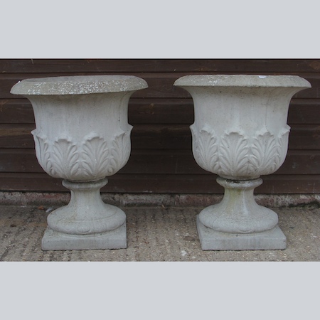 A pair of reconstituted stone campana shaped garden urns, 60cm tall