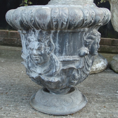 A lead garden urn, with fluted decoration, on a pedestal base, 48cm tall