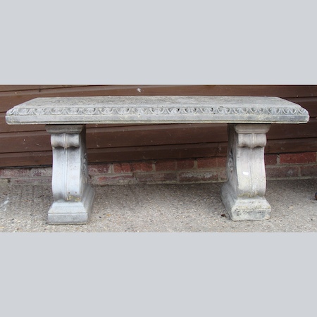 A reconstituted stone garden bench, on scrolled supports, 120cm