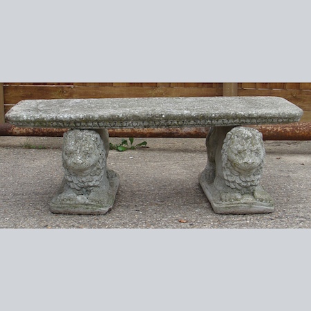 A reconstituted stone bench, on lion plinths, 123cm