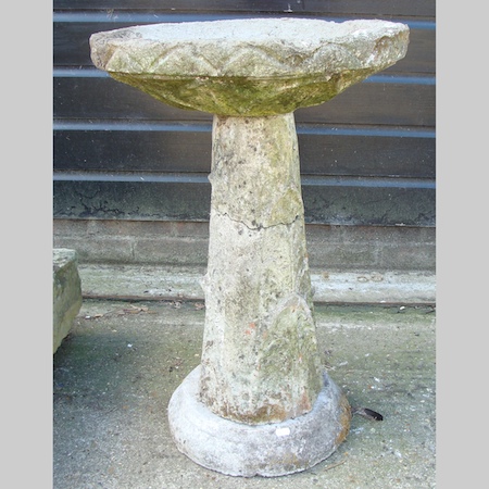 A reconstituted stone bird bath, on a pedestal base, 73cm tall