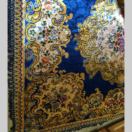 A modern Persian silk wall hanging,with a central medallion, on a blue ground, 240 x 120cm