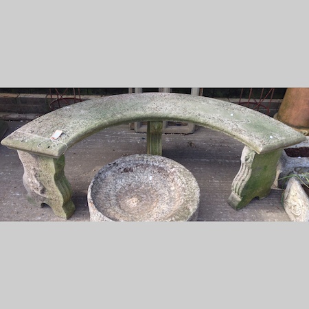 A reconstituted stone curved garden bench, 156cm