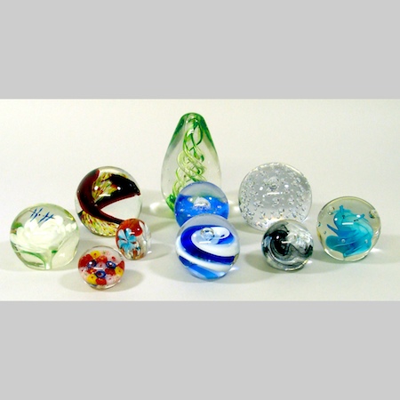 A collection of ten glass paperweights