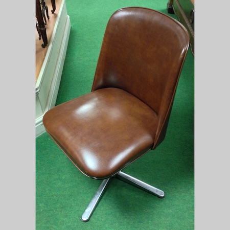 A set of four 1970`s brown upholstered swivel dining chairs, on chrome bases