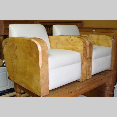 A pair of burr walnut and cream upholstered Art Deco style arm chairs