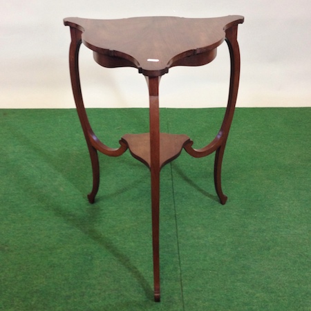 An Edwardian mahogany shaped triangular occasional table, 52cm