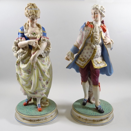 A pair of large late 19th century French bisque porcelain figures, of an 18th century style lady and