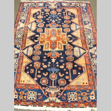 A Turkish rug, with geometric designs, on a red ground, 220 x 146cm