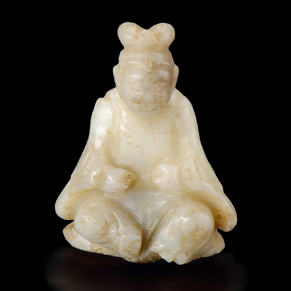 A WHITE AND RUSSET JADE BUDDHIST FIGURE SONG DYNASTY (960-1279) H 3.2 cm (1 1/4 in.) ? ????????