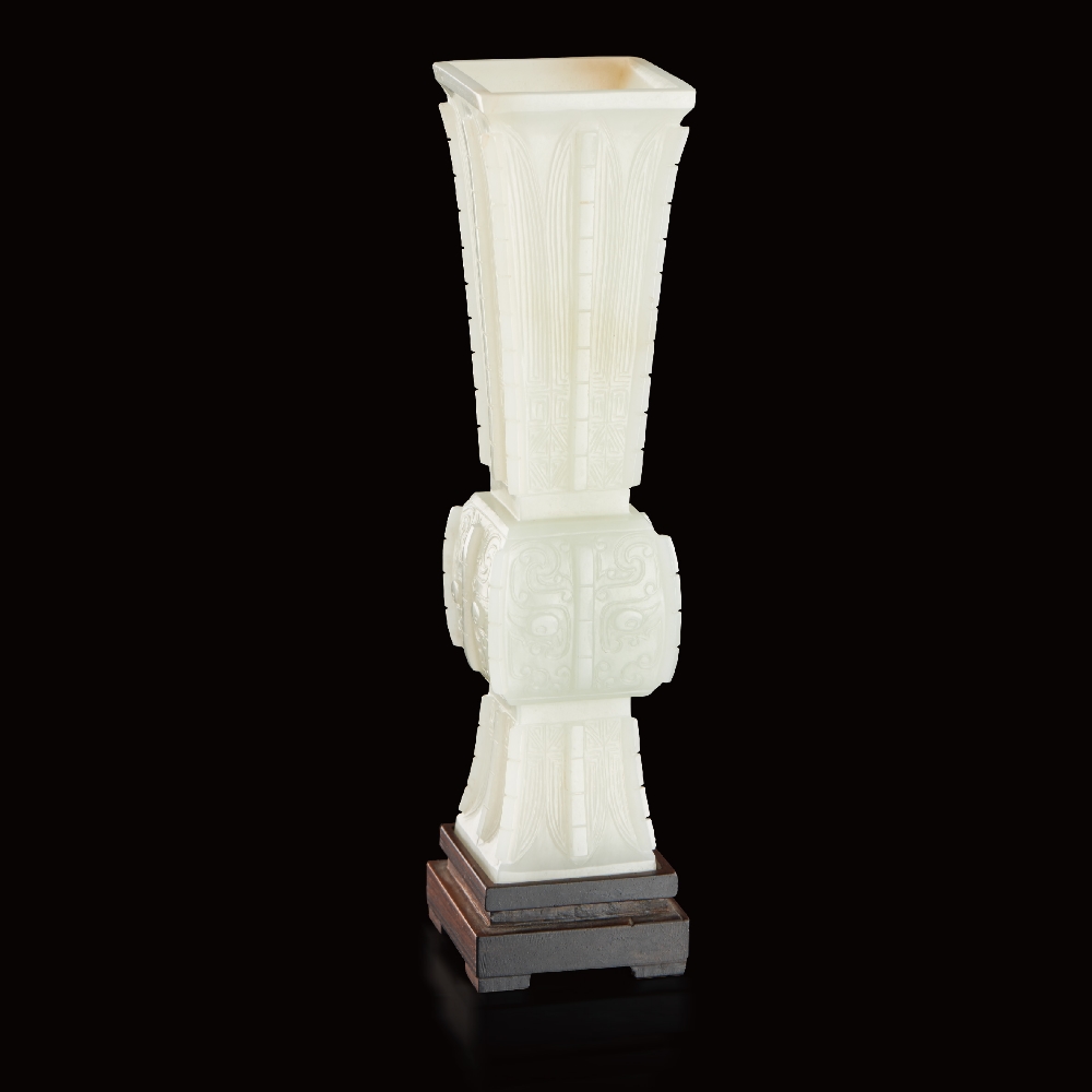 A WHITE JADE `TAOTIE MASK` ARCHAISTIC BEAKER VASE, FANG GU QIANLONG PERIOD (1736-1795) H 19.5 cm. (7