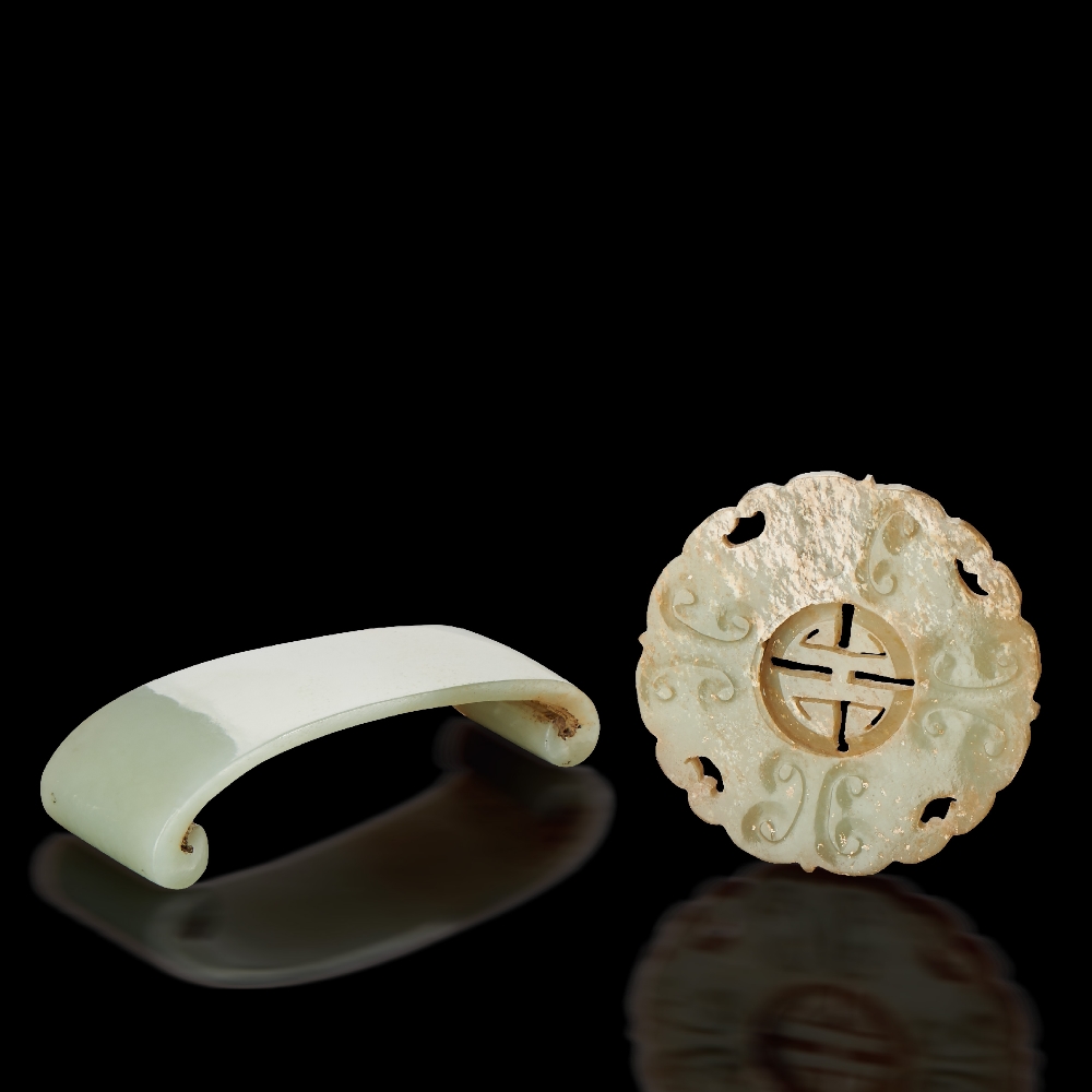 AN UNEARTHED PALE CELADON JADE PENDANT WITH MOVABLE CENTER AND A WHITE JADE INKSTONE REST QING