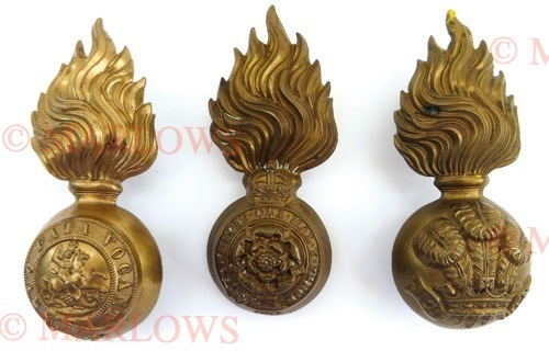 Four Various Busby Grenades consisting KC brass Royal Fusiliers (lug and slider) ... KC brass