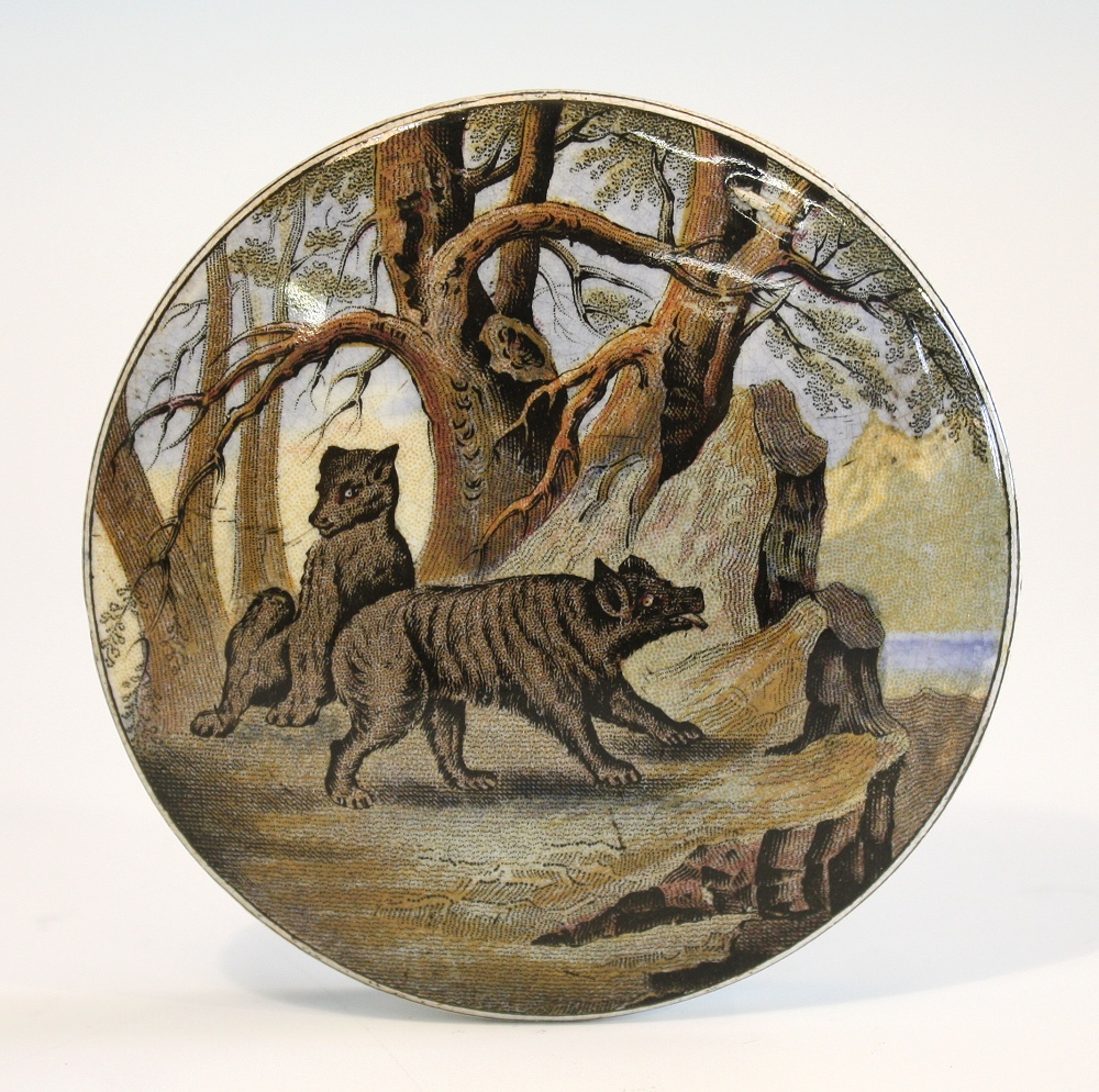 A Prattware pot lid `Bears on Rocks`. a mid 19th century Bears Grease pot lid depicting two brown