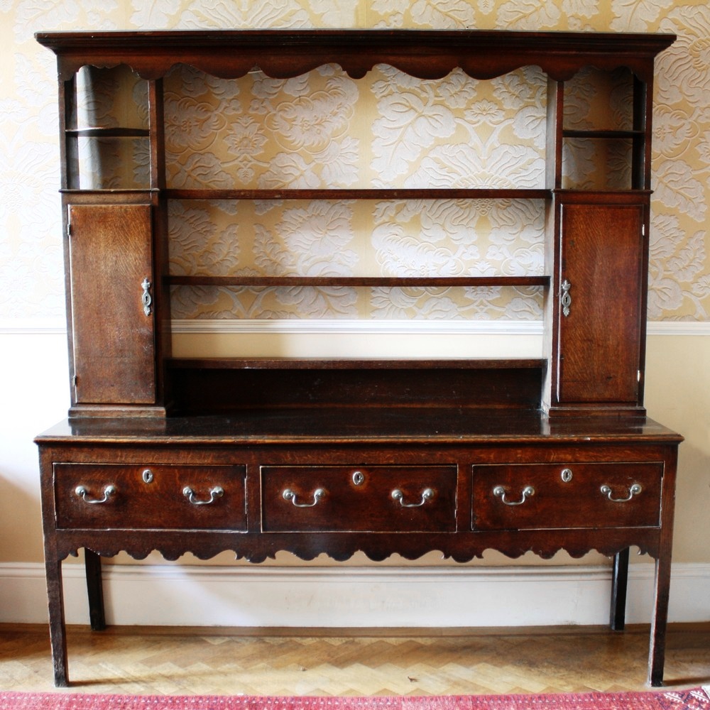 An 18th century oak and mahogany cross banded dresser the base with three deep drawers, original