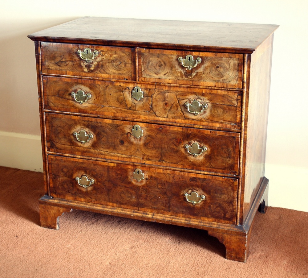 A Charles II laburnum oyster veneered chest of drawers the fruitwood cross banded moulded top with