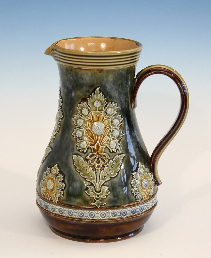 A Doulton Lambeth stoneware jug late 19th century, baluster form, upper rim edge with reeded