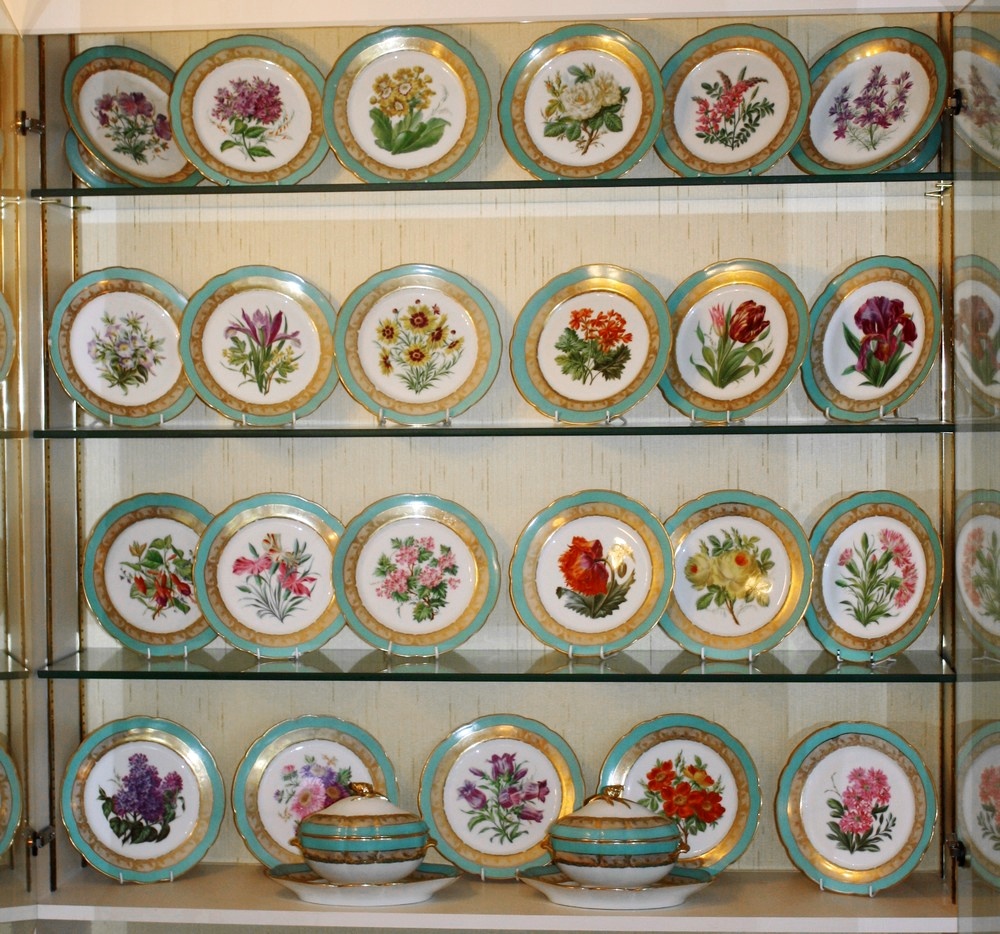 A Paris porcelain dessert service painted with flowers within turquoise gilded borders, the reverse