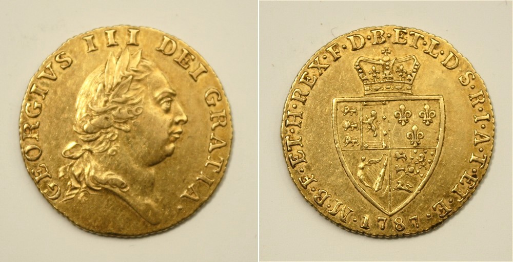 A 1787 George III gold spade guinea 5th laureate head, spade-shaped shield to reverse, milled edge.