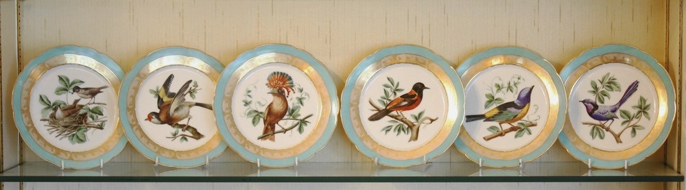 A set of seven Paris porcelain cabinet plates the centres painted with various birds, within