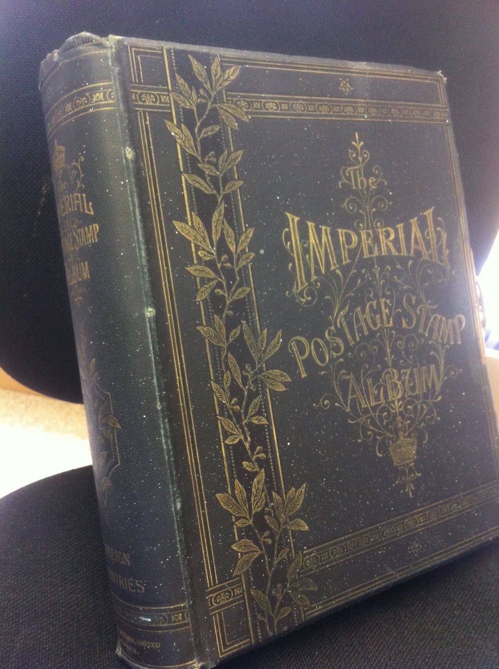 1898 Imperial printed album with metal clasp & gilt edged leaves (no stamps). Binding intact &