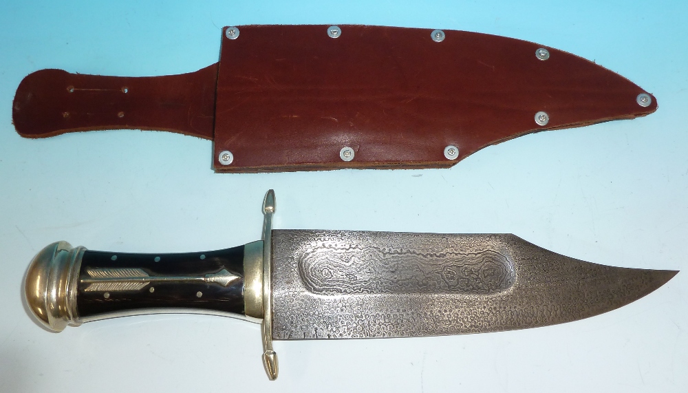 A large Bowie knife with Damascus steel finish to the blade, brass mounted horn handle, 17