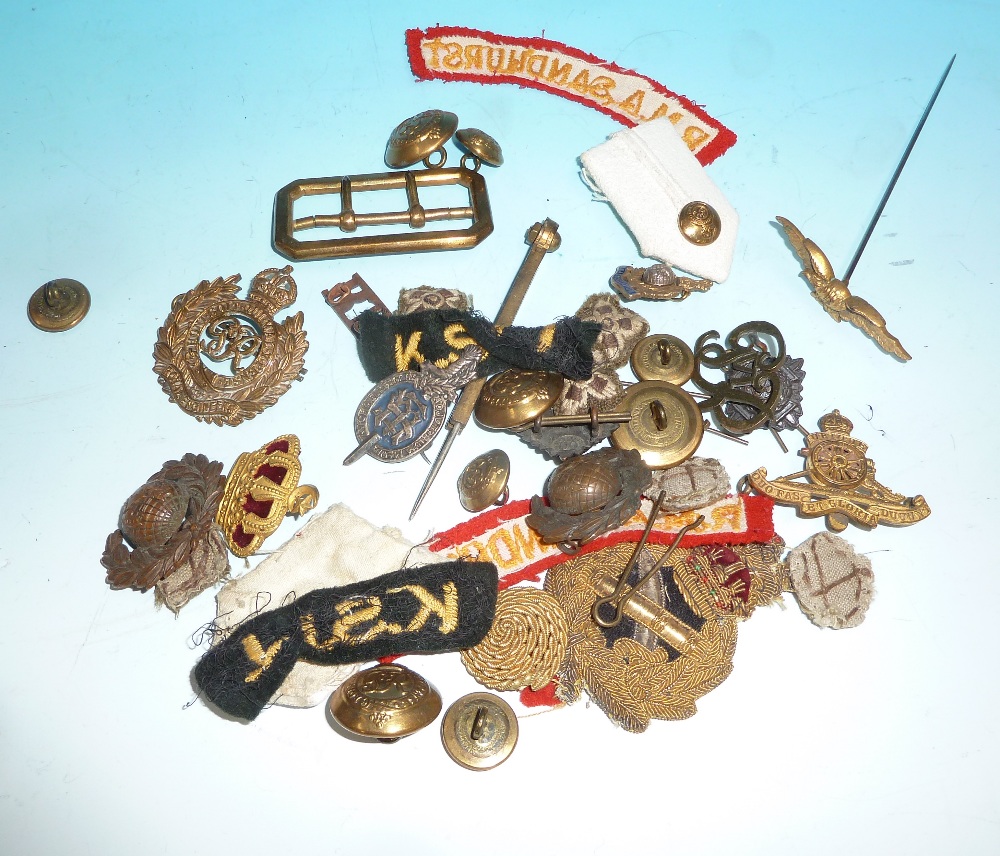 A selection of military cap badges; buttons; etc.