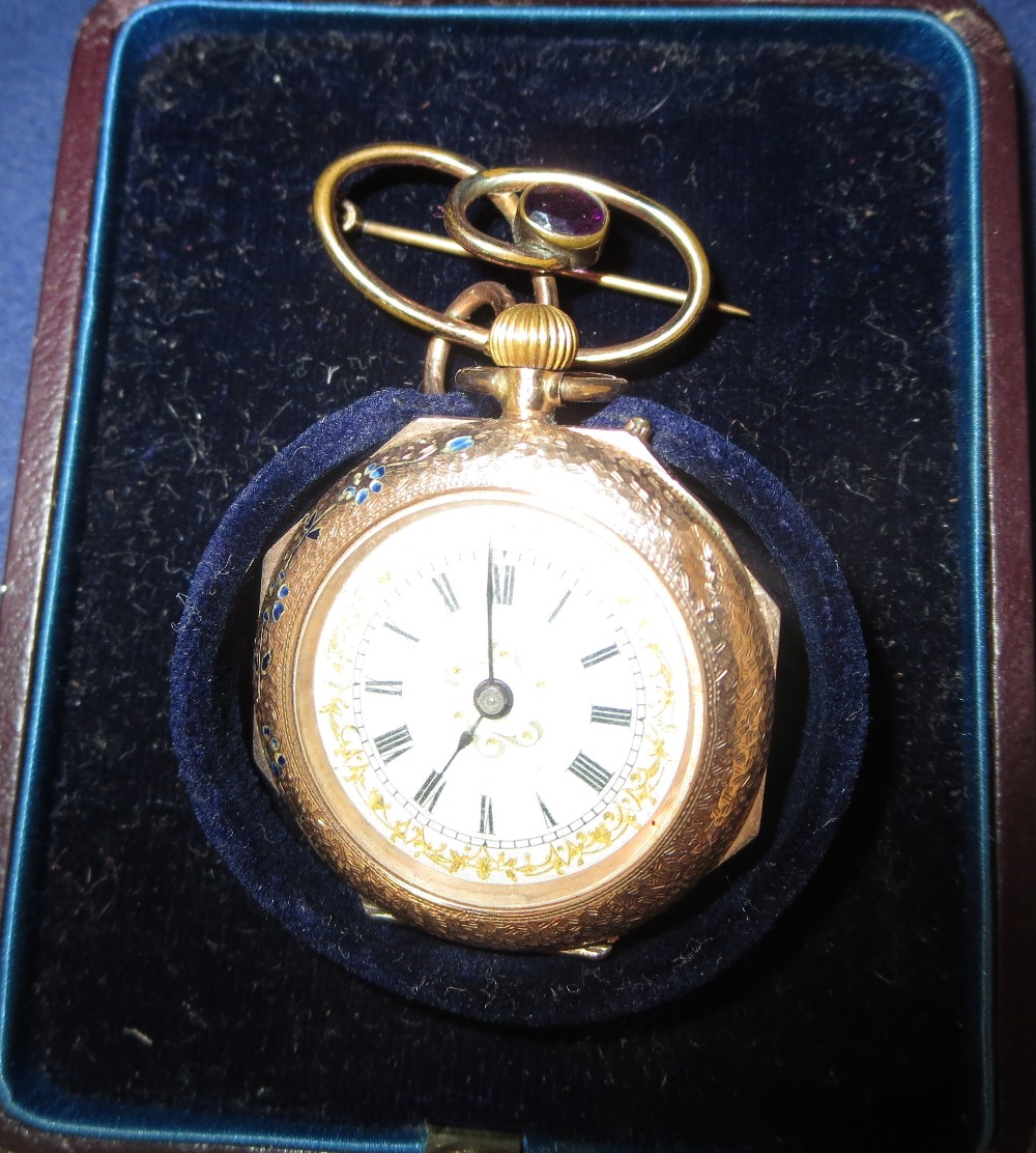 An Edwardian chased and enamelled 9 carat hallmarked gold fob watch on silver plated loop