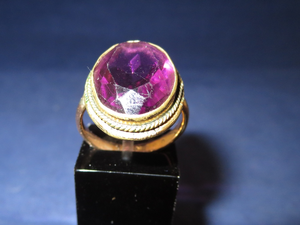 A Victorian 9 carat hallmarked gold dress ring set with a large amethyst