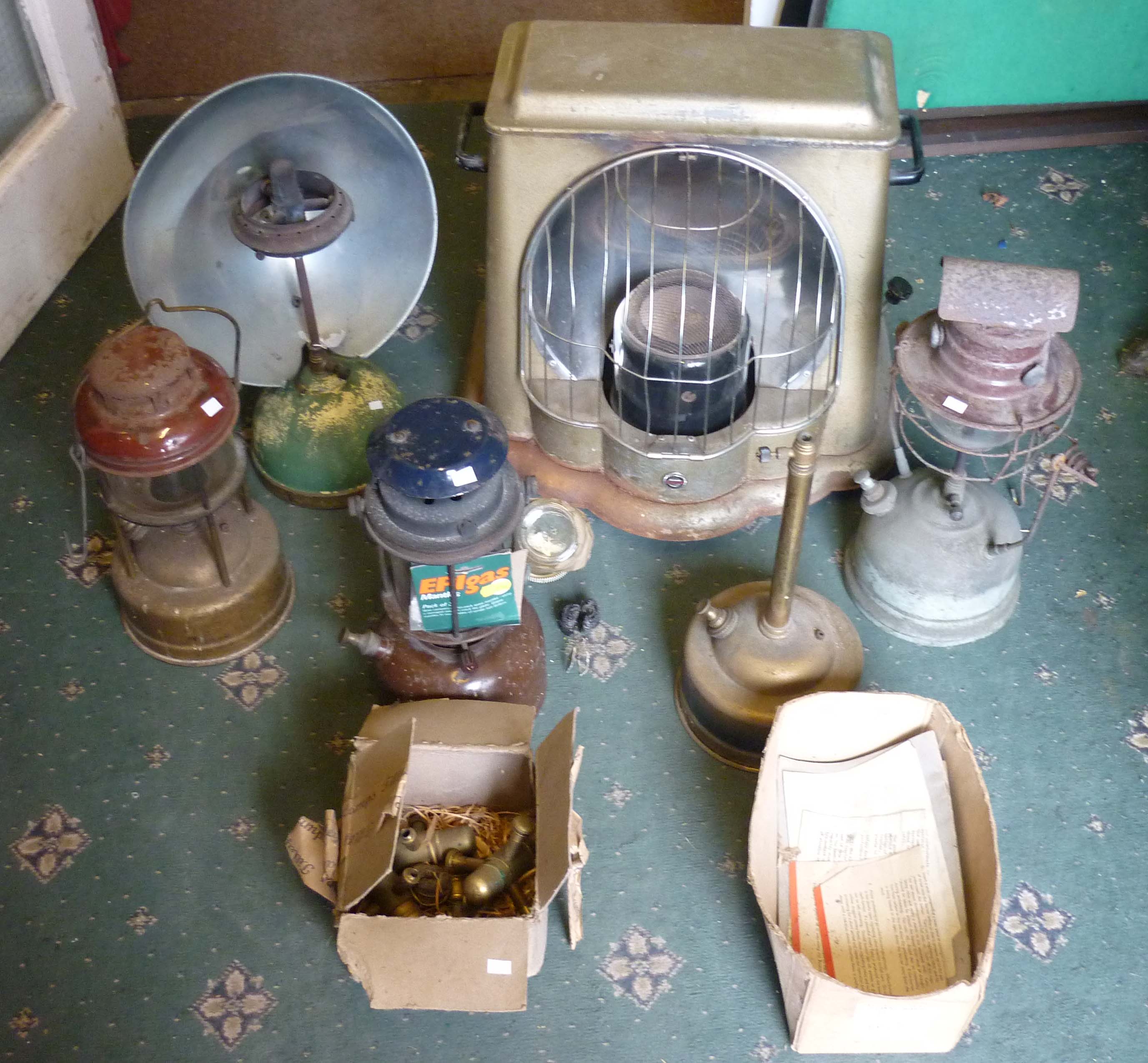 Five vintage parafin lamps, floor heater and accessories