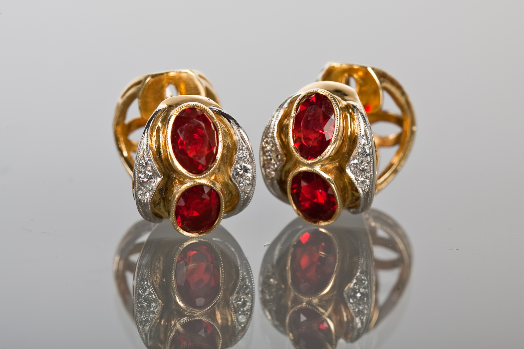 PAIR OF FINE RED GEM AND DIAMOND EARRINGS each set with two oval cut red gems and two borders of