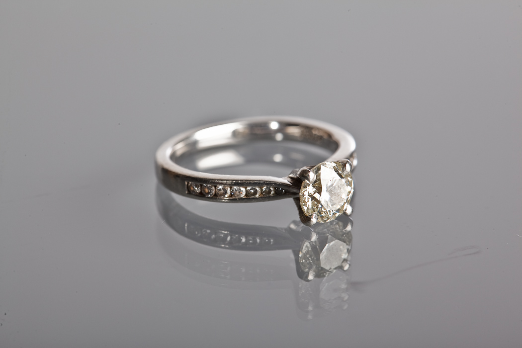 DIAMOND SOLITAIRE RING the brilliant cut diamond approximately 0.90 carats, on channel set