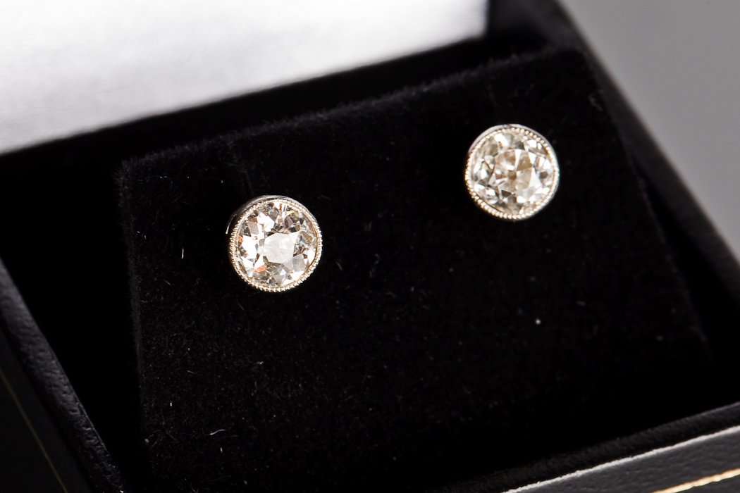 PAIR OF EARLY TWENTIETH CENTURY DIAMOND STUD EARRINGS each set with an old brilliant cut diamond of