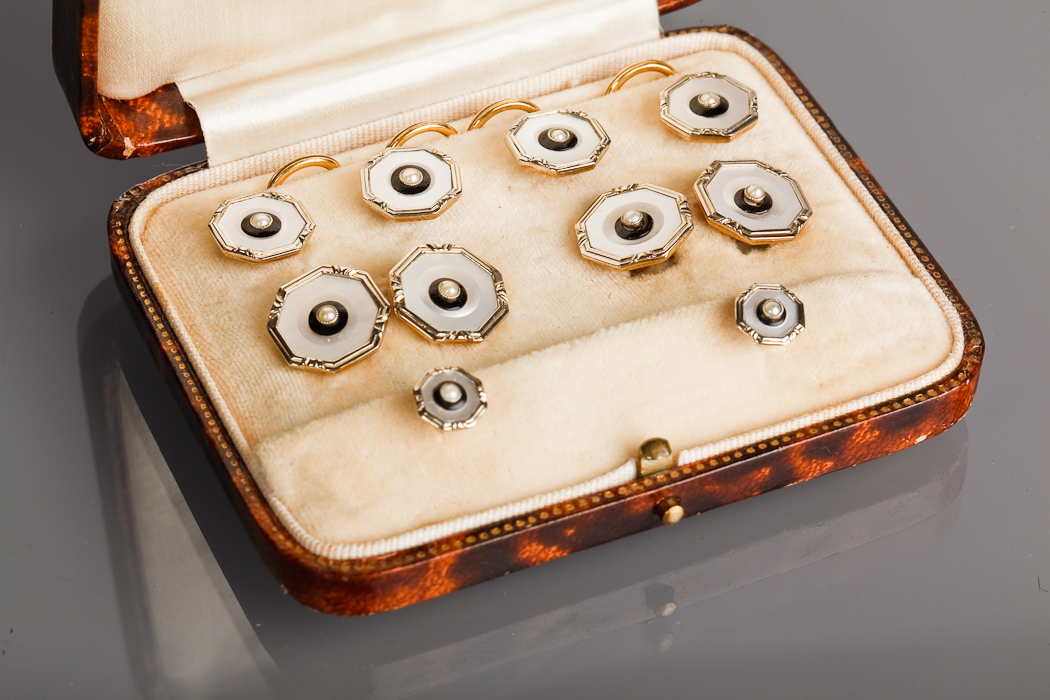 EARLY TWENTIETH CENTURY MOTHER OF PEARL AND SEED PEARL STUD SET in fourteen and eighteen carat