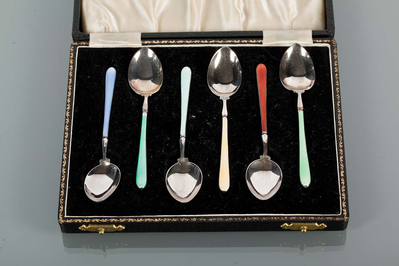 SET OF SIX 20TH CENTURY SILVER AND ENAMEL COFFEE SPOONS  maker HCD, Birmingham marks, cased, 10cm