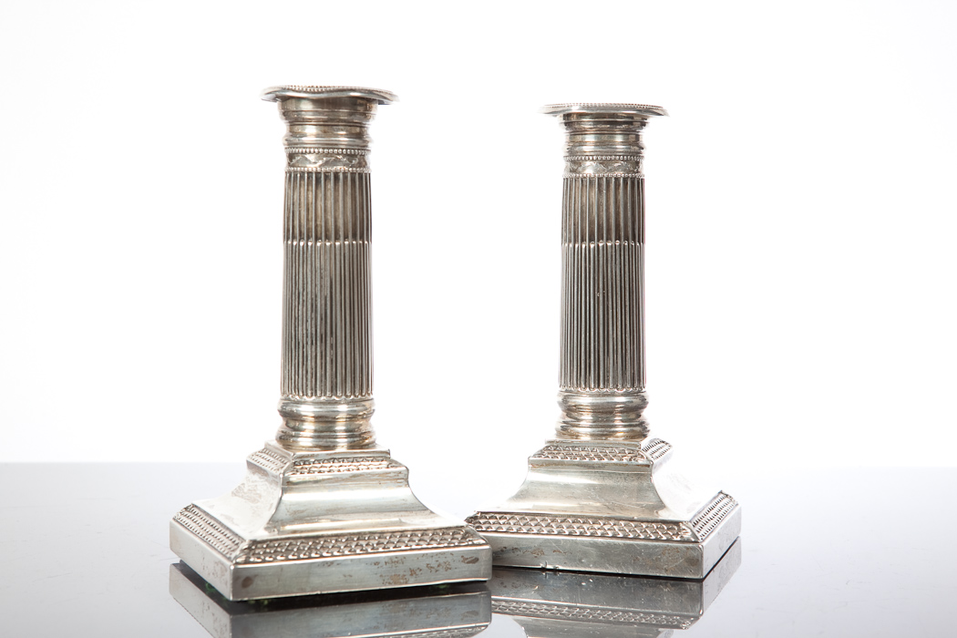 PAIR OF SILVER DWARF CANDLESTICKS with demi fluted columns on square bases, Chester hallmarks,