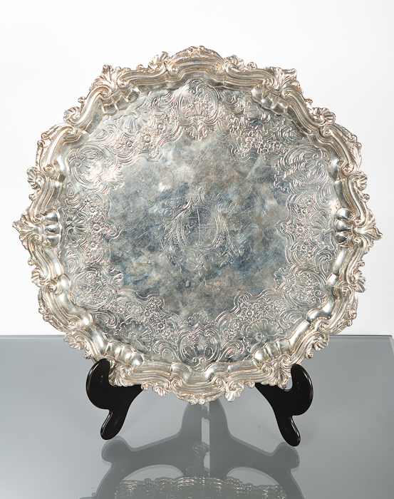 GEORGE II SILVER SERPENTINE CIRCULAR TRAY with central coat-of-arms within a chased shell and