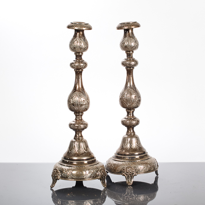 PAIR OF GEORGE V SILVER CANDLESTICKS with stepped baluster shaped stems and domed bases, with