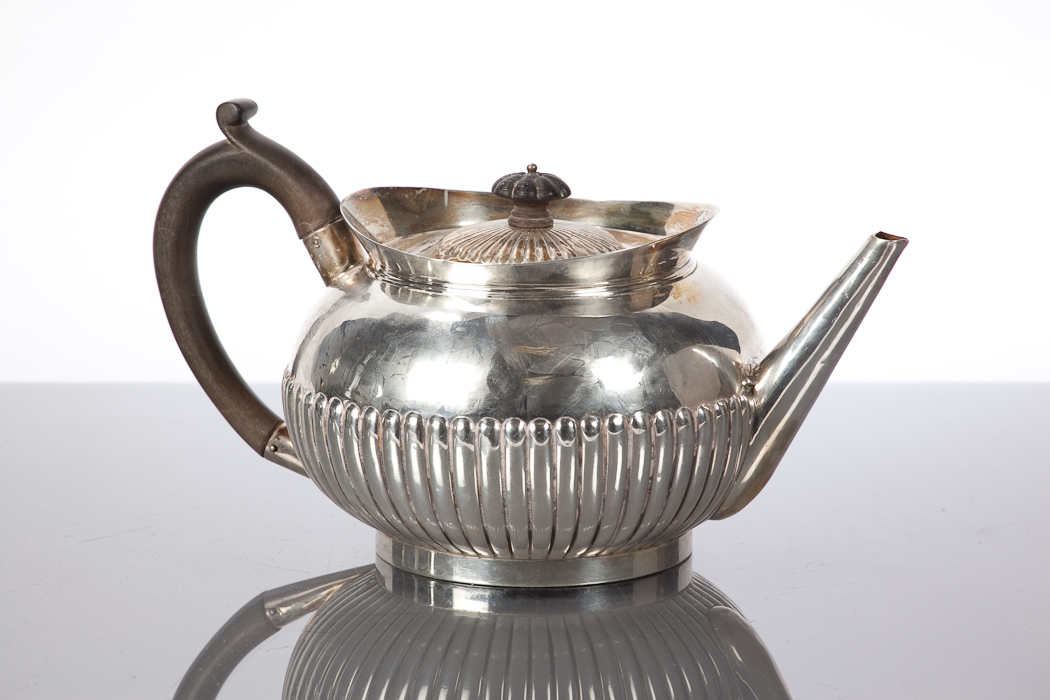 SILVER TEAPOT of gadrooned circular form, marks rubbed and indistinct, approximately 577g