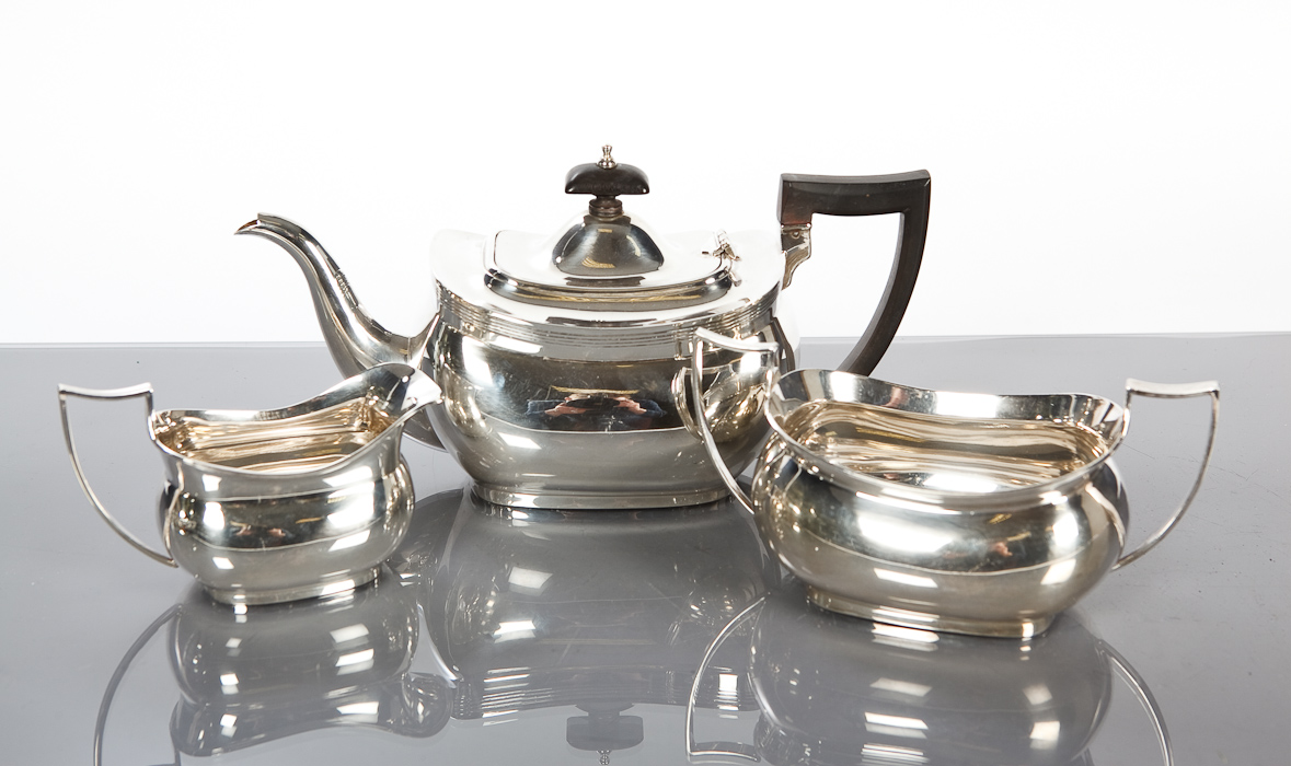 20TH CENTURY SILVER THREE PIECE TEA SERVICE of rectangular form, with reeded borders, Chester