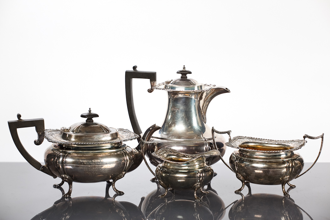 SILVER FOUR PIECE TEA SERVICE of rectangular form, with shell cast gadrooned and foliate pierced