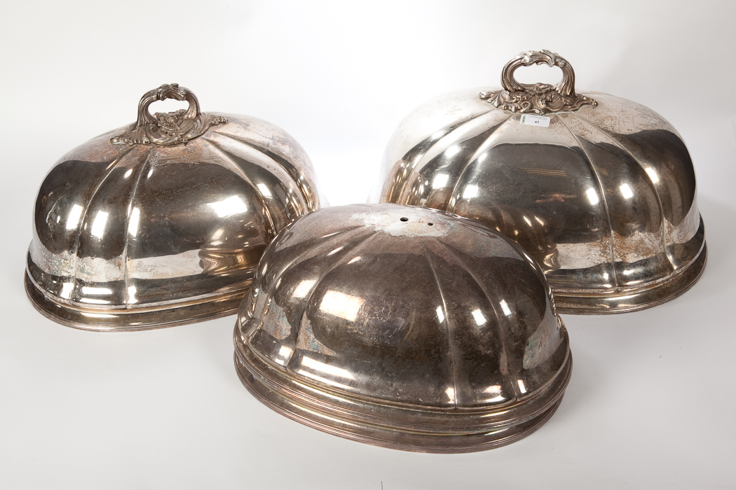 EDWARDIAN SET OF FOUR SILVER PLATED GRADUATED OVAL MEAT COVERS the largest 26cm high, 51cm wide Two