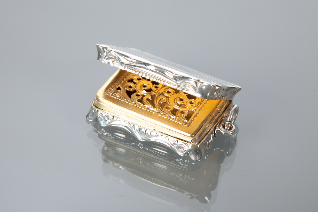 VICTORIAN SILVER VINAIGRETTE of shaped rectangular form, the gilded interior with pierced grill,