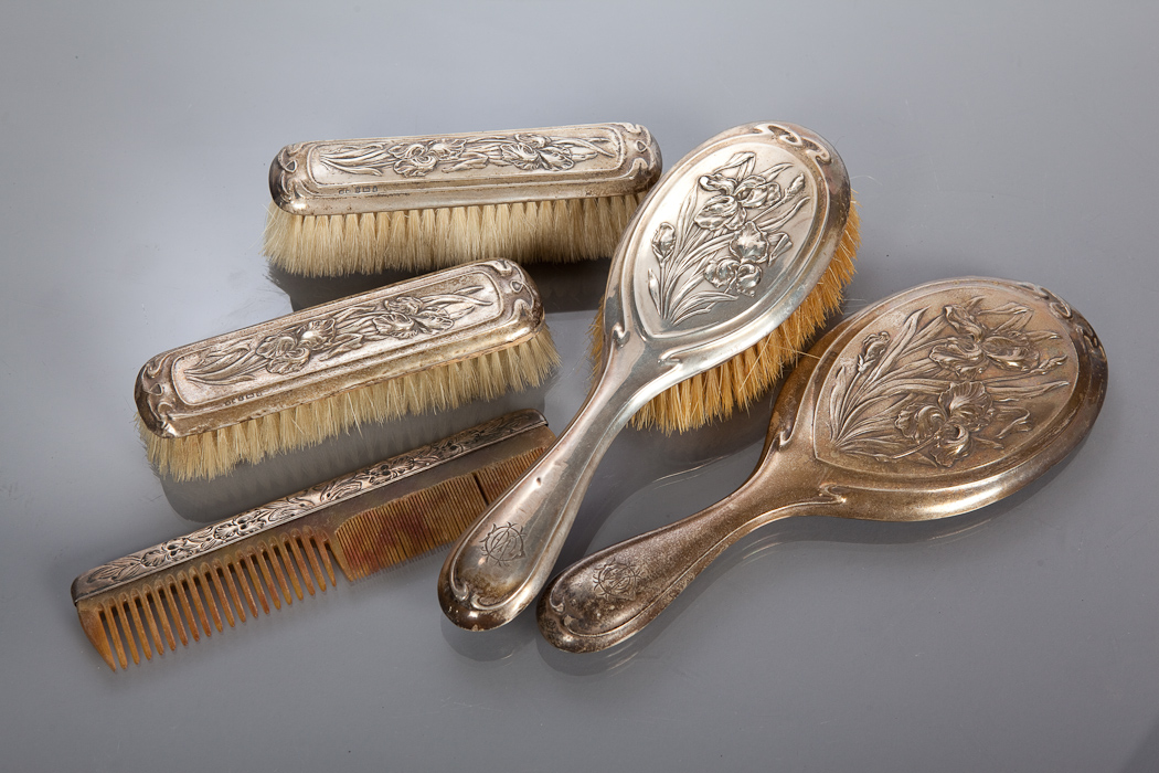 ART NOUVEAU SILVER VANITY SET comprising hand mirror, hand brush, two brushes and a comb, each with